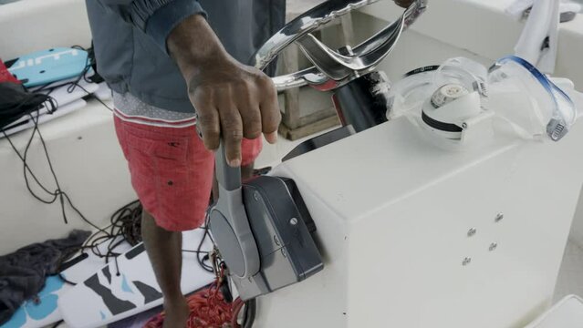 Man's hand on boat accelerator - close up