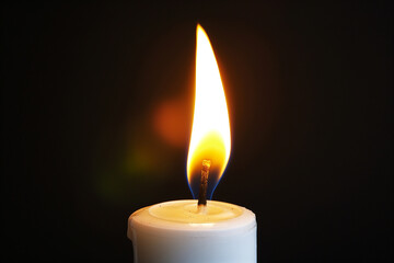Single Candle Flame on Dark Background