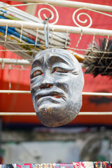 classic and unique traditional masks hanging in a market stall