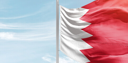 Bahrain national flag with mast at light blue sky. - obrazy, fototapety, plakaty