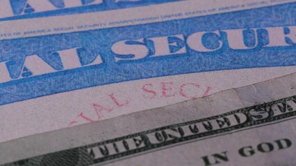 2 close up social security cards ssn cash US dollar bills money