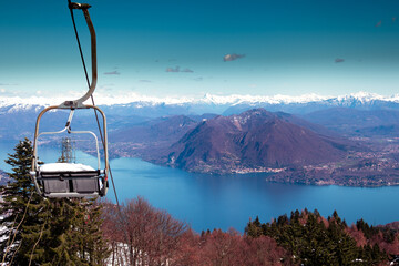The major lake in a bright March morning. Charming view from the chairlift, after a snowfall, Lake...