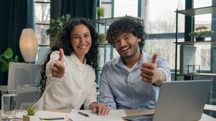 Happy business people ethnic gender diversity workers Arabian businessman Indian businesswoman colleagues working together with laptop showing thumbs up gesture best choice offer in corporate office
