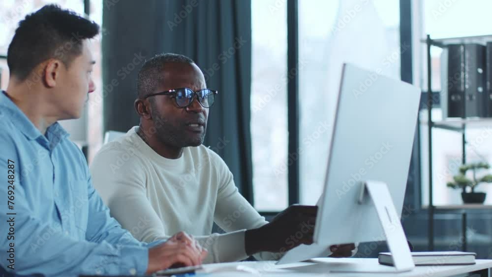 Poster two men looking at computer screen