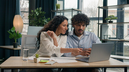 Arabian female leader coach help intern explain paperwork and financial data business strategy...