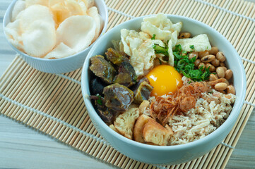 Bubur Daging Spesial or Special Meat Porridge contains white rice with side dishes of grilled beef slices