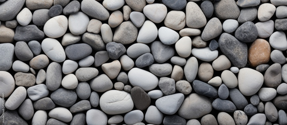 Poster a collection of assorted rocks stacked together with a single tiny stone positioned in the middle