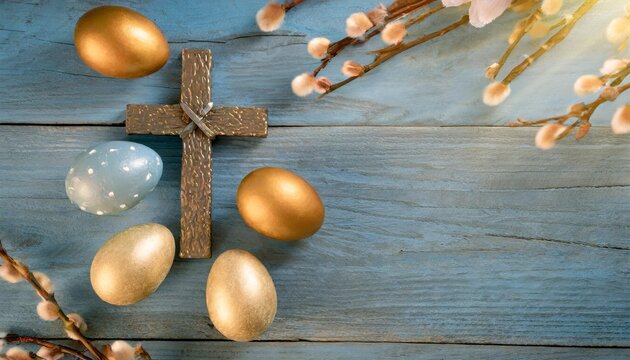 cross and easter eggs on a blue wood background with copy space