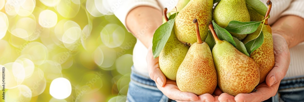 Poster hand selecting fresh pear with copy space on blurred background for text placement