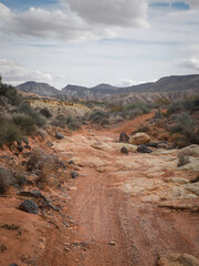 Rocky trail through St. George utah desert landscape with buttes in background