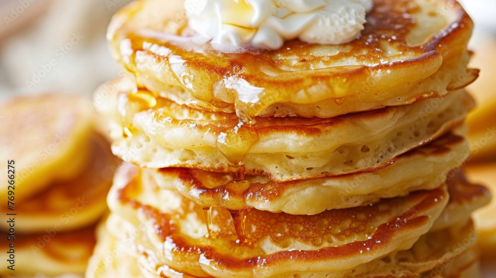 Poster a stack of fluffy pancakes piled high and topped generously with whipped cream, ready to be devoured
