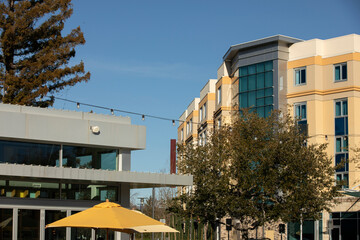 Afternoon sun shines on the buildings of downtown Cupertino, California, USA.