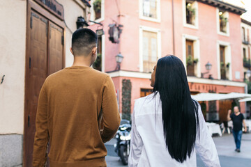 Interracial couple walking on the city street
