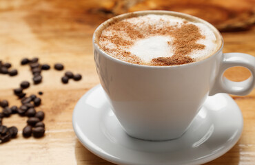 cup of cappuccino espresso coffee topped with frothed hot milk or cream and often flavored with cinnamon
