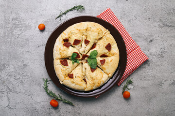 Top view of pepperoni pizza with meat on grey background