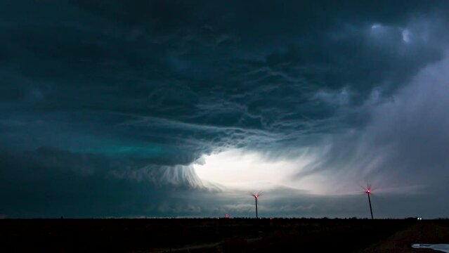 Overnight supercell thunderstorm lights up the sky with beautiful structure below.