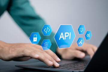 API, Application programing interface concept, software development tool, information technology. Businessman using laptop with API icon on virtual screen. - obrazy, fototapety, plakaty