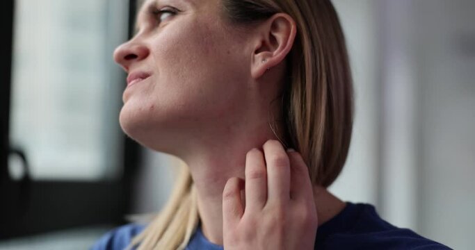 Woman scratches neck suffering from eczema disease