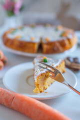 Carrot cake pie sprinkled with nuts decorated with cream-colored carrots