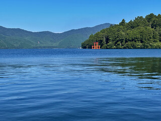Mountains Beyond Hakone Lake and Red Jinja Torii Temple Gate, Kanagawa Prefecture, JapanMountains...