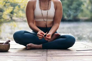 Foto op Plexiglas Young woman meditating and doing yoga in nature © PEDROMERINO