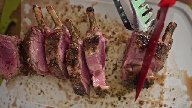 Slicing The Last Pieces Of The Lamb Rack - A Perfectly Roasted Delight Served On The Table