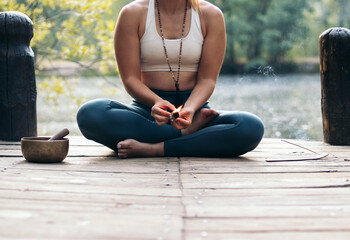 Young woman meditating and doing yoga in nature