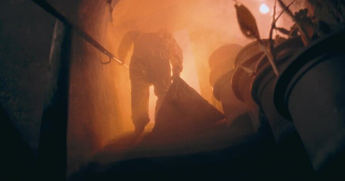 The video captures a person entering a dark nuclear bunker wearing a protective suit after a nuclear aftermath, emphasizing caution and readiness in a hazardous environment.

