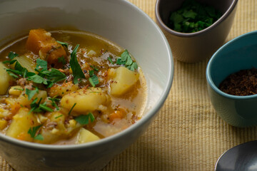 Typical Chilean food called Carbonada. It is a broth whose ingredients are: cooked potato, pumpkin, corn, parsley or cilantro, peas and beef (cut or ground)