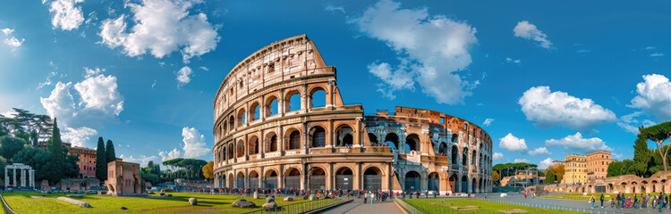 panoramic view of the Colosseum and Arch of Constantine in Rome, Italy with green grass on a sunny...