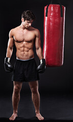 Boxing, man and training in studio with punching bag for workout, exercise or fight competition...