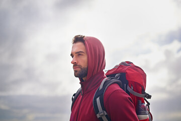 Outdoor, sky and man with backpack, bottle and nature for adventure, peace and travel. Contemplation, thinking and male person in vacation, thoughtful and journey for holiday, trip and break