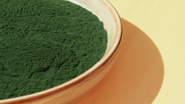 Rotating Natural organic green spirulina algae powder in bowl on neutral background. Chlorella seaweed vegan superfood supplement source and detox. Copy space Healthy nutritional antioxidant concept 