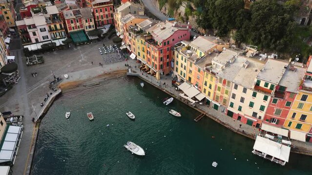 Colorful portofino waterfront and boats, calm sea, italian riviera charm, late afternoon light, aerial view