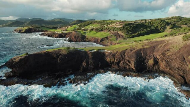 Atlantic Ocean waves crashing on rocky shore, in Saint Lucia. Tropical Caribbean landscape