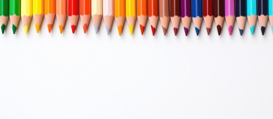 An array of vibrant colored pencils are displayed on a blank canvas. The assortment includes hues...