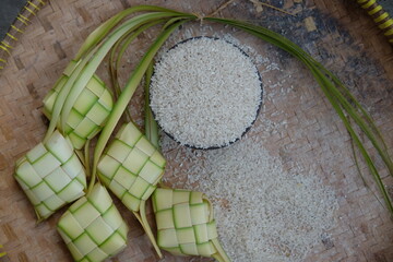 ketupat and rice on a woven bamboo mat