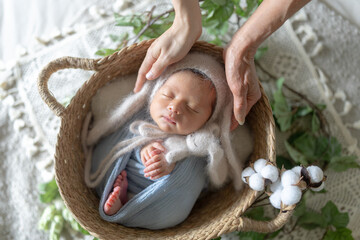 Newborn photo of an 8-day-old Taiwanese and half-Australian newborn baby sleeping in a basket in a...