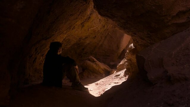 Man Sitting Under The Cave Of Rock Formation In Quebrada del Diablo In Chile. - static shot