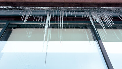 Icicles hang from a glass building