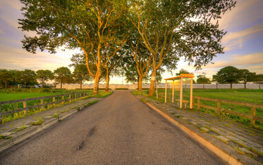 Country road in rural Holland at sunset.