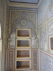 A palace wall adorned with a floral painting and decorative lines, Nahargarh fort Jaipur Rajasthan India