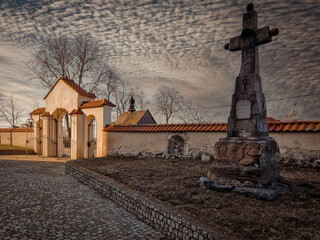 Historic buildings of the church and village in Tum, Poland. - obrazy, fototapety, plakaty