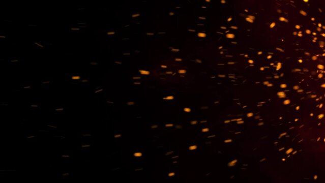 Flying Fire Sparks: Dynamic Embers Footage Against Black Background with Firestorm Texture and Bokeh Lights. Close-up of Burning Bonfire Flames.