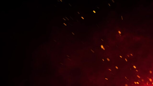 Flying Fire Sparks: Dynamic Embers Footage Against Black Background with Firestorm Texture and Bokeh Lights. Close-up of Burning Bonfire Flames.