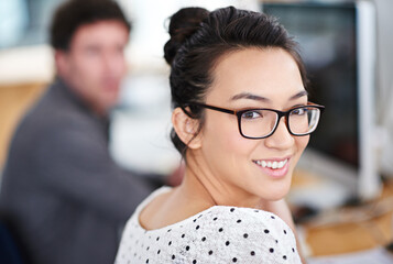 Portrait, smile and business woman in office of creative startup company for coworking, job and career. Face, happy professional and entrepreneur with glasses, designer and employee in workplace