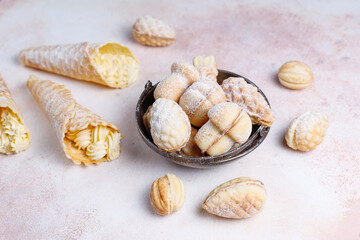 Homemade nut shaped russian soviet cookies and wafer rolls with pastry cream.