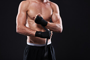Wrapping, hands and man in martial arts for boxing on black background in studio with preparation closeup. Tape, fist and ready to start training as boxer in mma or gym with fitness and mockup space