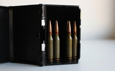 Assault Rifle Bullets Staying In Rows Inside Black Ammunition Container  
