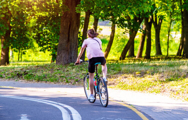 Fototapeta premium Cyclist ride on the bike path in the city Park 